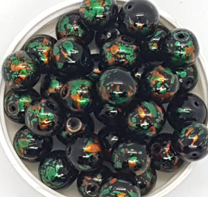 12MM GLASS BEADS - 20 PER PACKET - BLACK WITH GREEN AND ORANGE SPLASH